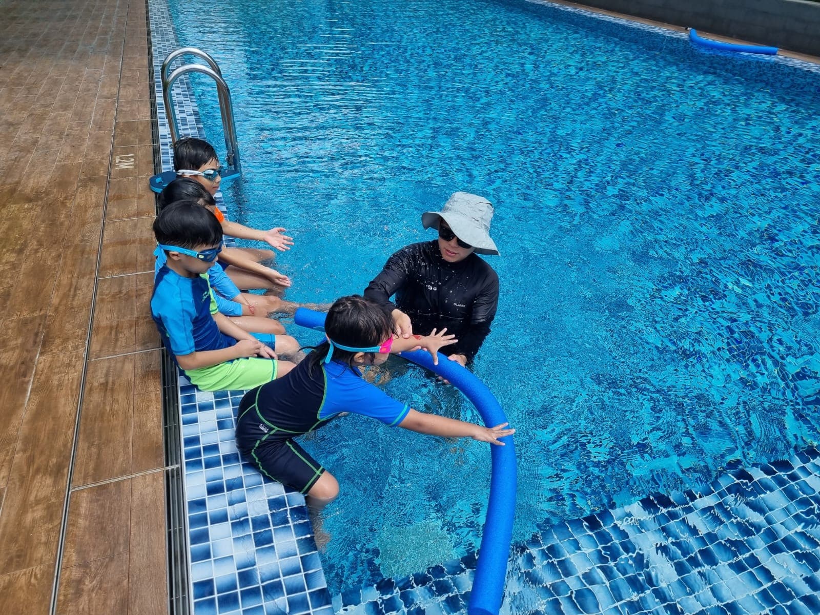 Overhead view of a swimming lesson at a public pool in Singapore